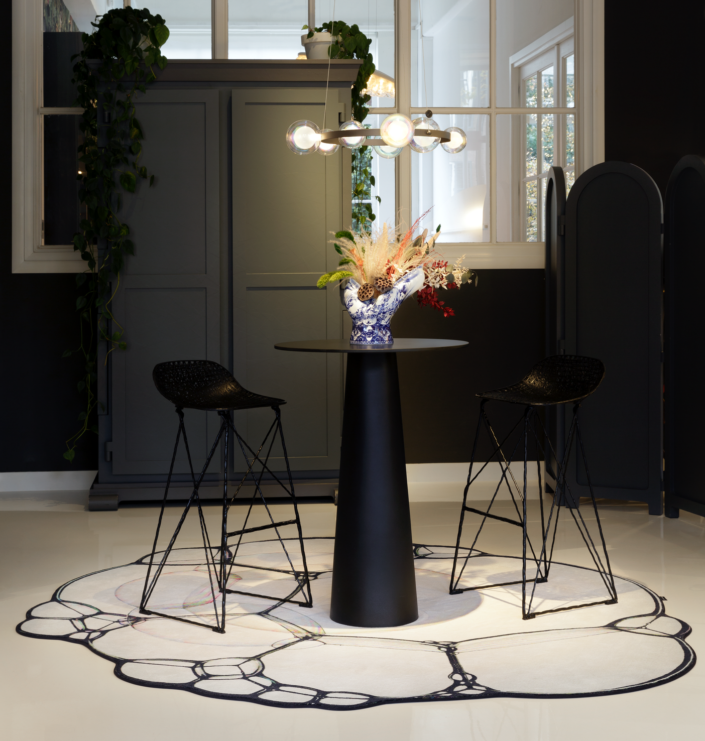 Moooi containter bar table on bubble carpet with carbon barstools