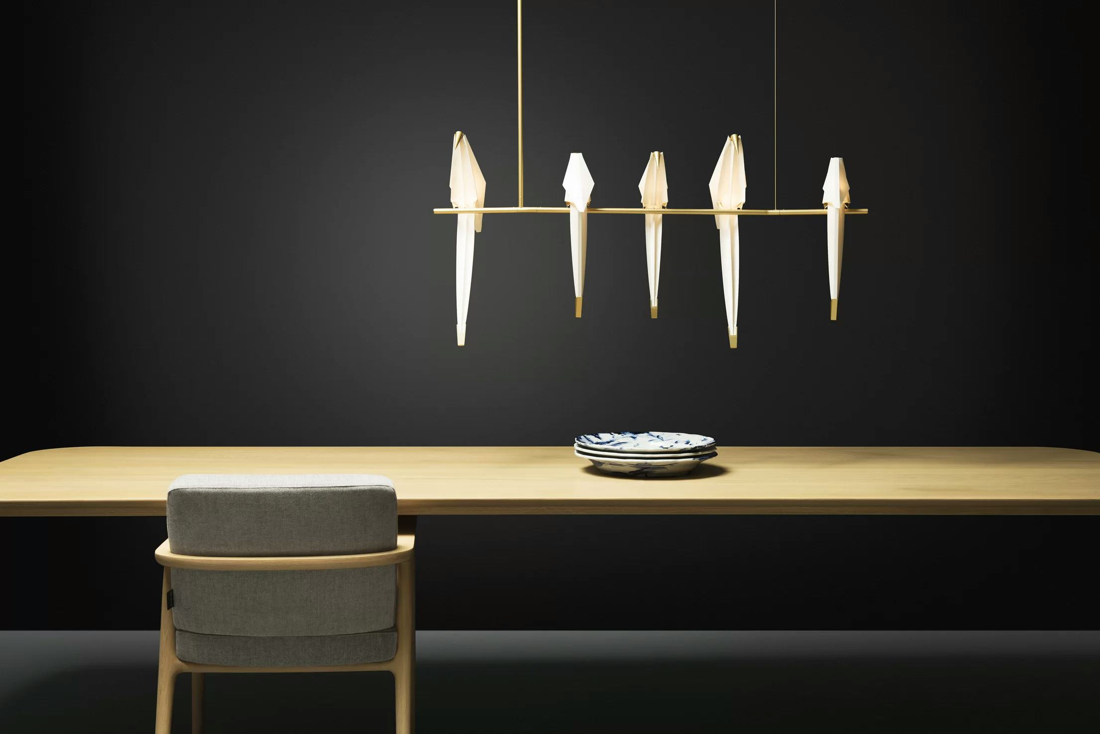 Perch Light Branch above dining table with black background